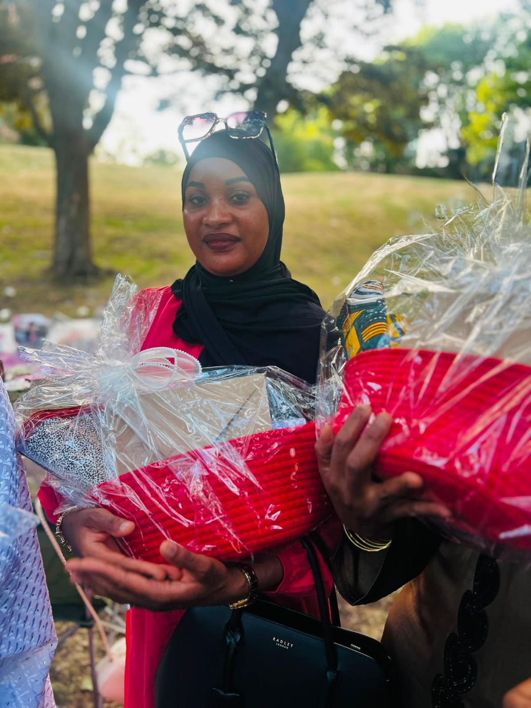 A member holding two gift hampers