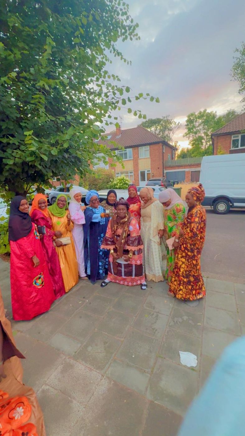 Members arriving at an event in vibrant outfits