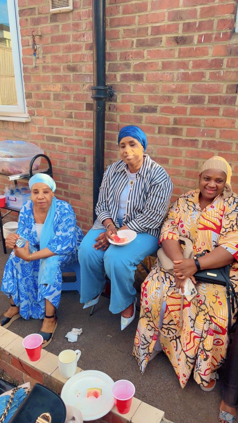 Three members relaxing together outdoors