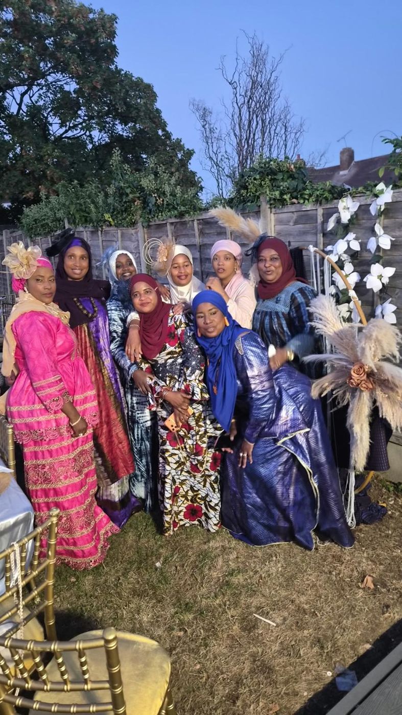 A big group of members at an evening garden event
