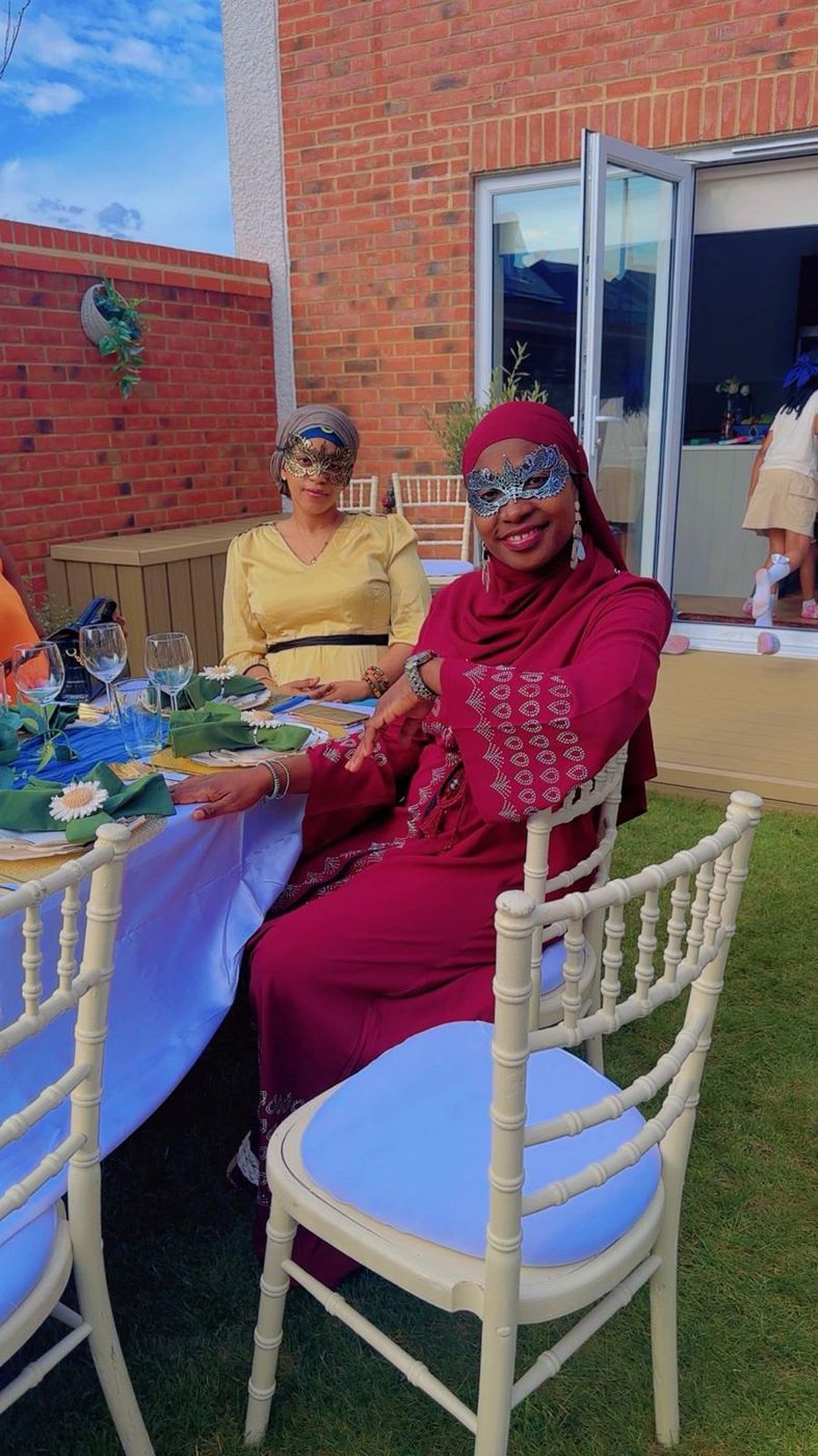 Members seated around a decorated garden party table