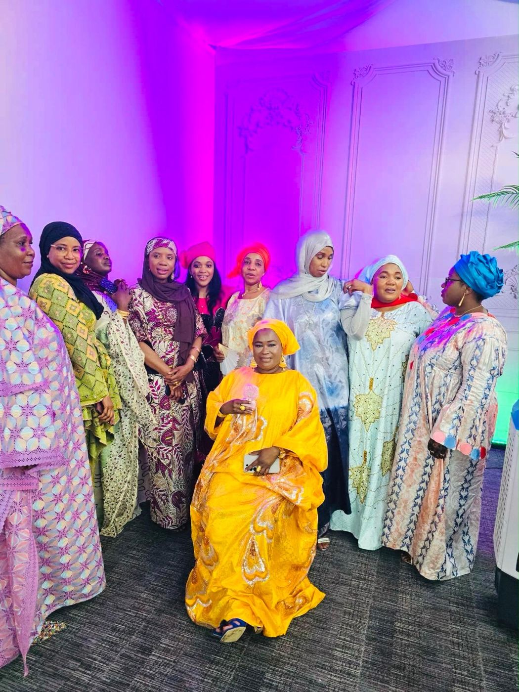 Members in colourful traditional outfits at an evening event
