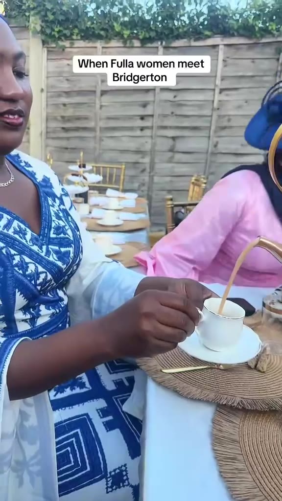 Video: members in elegant traditional dress at a garden tea party